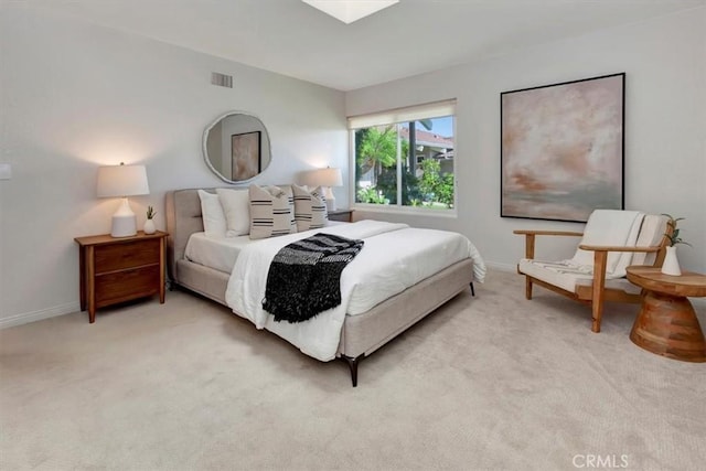 bedroom with light carpet, visible vents, and baseboards