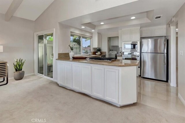 kitchen featuring stainless steel appliances, a peninsula, visible vents, and white cabinets