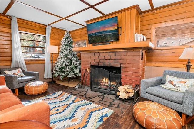 living room with a brick fireplace and dark hardwood / wood-style floors