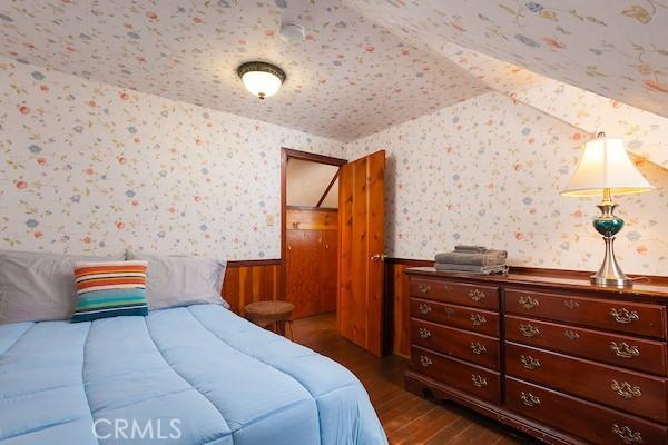 bedroom with dark hardwood / wood-style floors