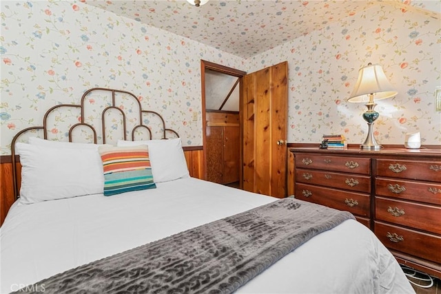 bedroom featuring wooden walls