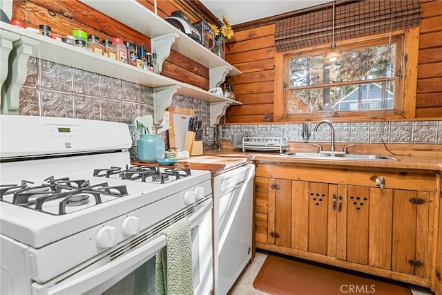 kitchen featuring white appliances, hanging light fixtures, wood counters, and tasteful backsplash