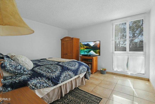 bedroom featuring a textured ceiling and tile patterned floors