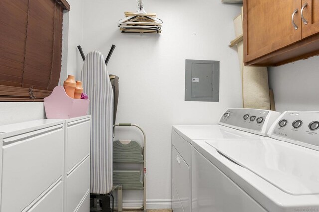 laundry area with washer and dryer, cabinets, and electric panel