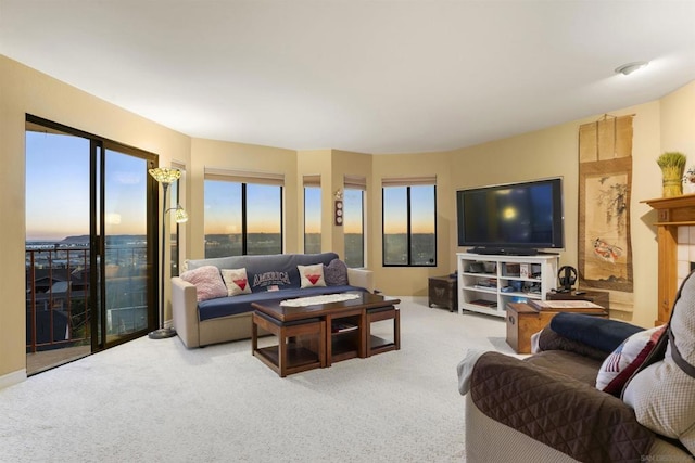 living room featuring carpet and a fireplace