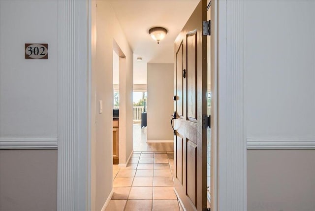 corridor featuring light tile patterned floors