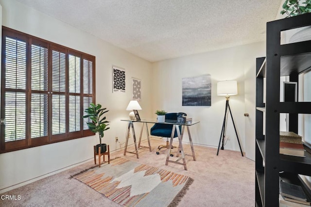 carpeted home office with a textured ceiling