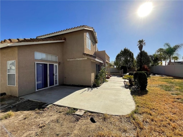 rear view of property featuring a yard and a patio