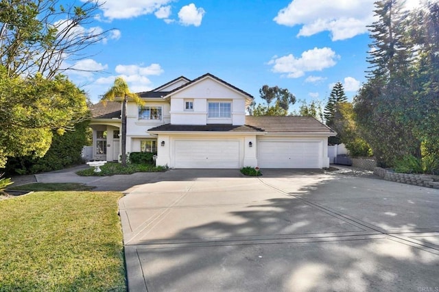 view of front of house with a garage and a front lawn