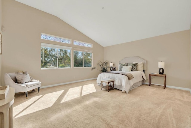 bedroom featuring high vaulted ceiling and light carpet