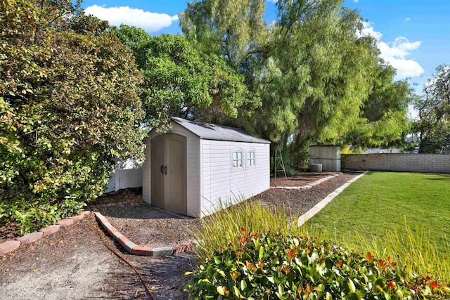 view of outbuilding featuring a lawn