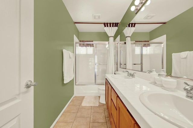 full bathroom featuring enclosed tub / shower combo, tile patterned floors, toilet, and vanity