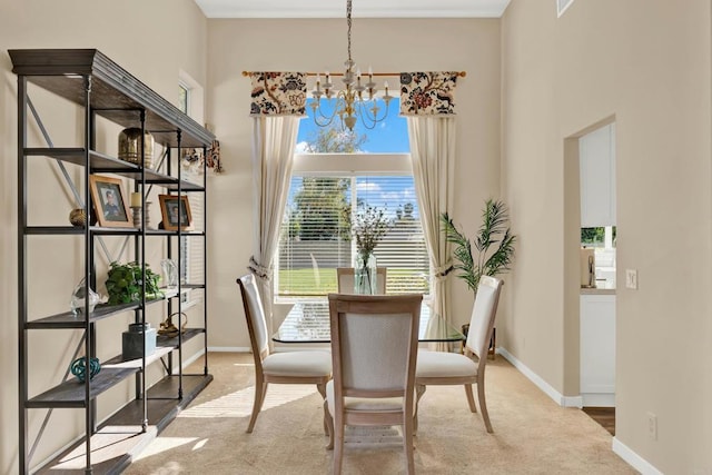 carpeted dining area with a towering ceiling and an inviting chandelier