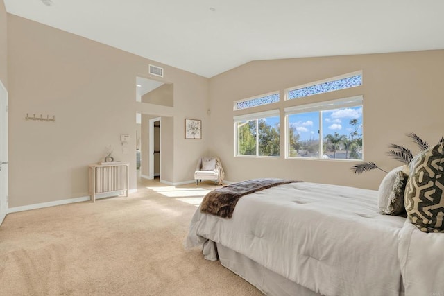 bedroom featuring vaulted ceiling and light colored carpet