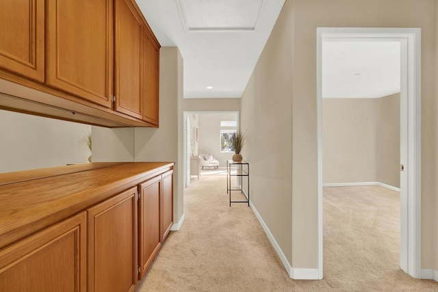 hallway featuring light colored carpet