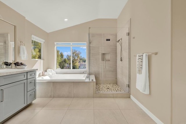 bathroom with tile patterned flooring, vaulted ceiling, independent shower and bath, and vanity