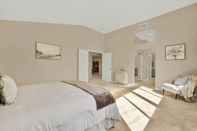 bedroom featuring light carpet and vaulted ceiling