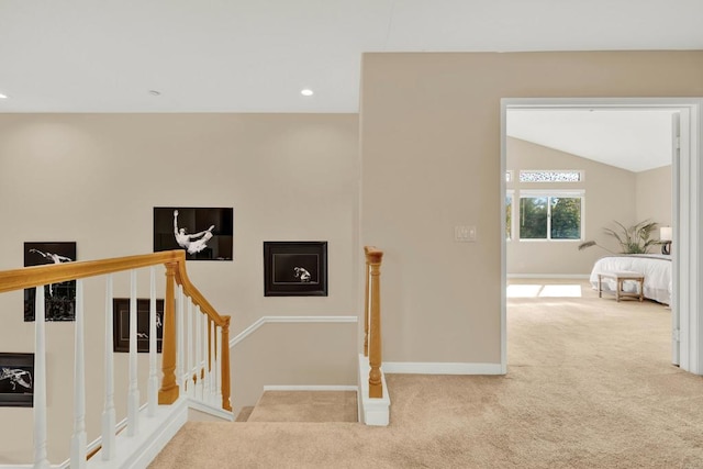 staircase with vaulted ceiling and carpet flooring