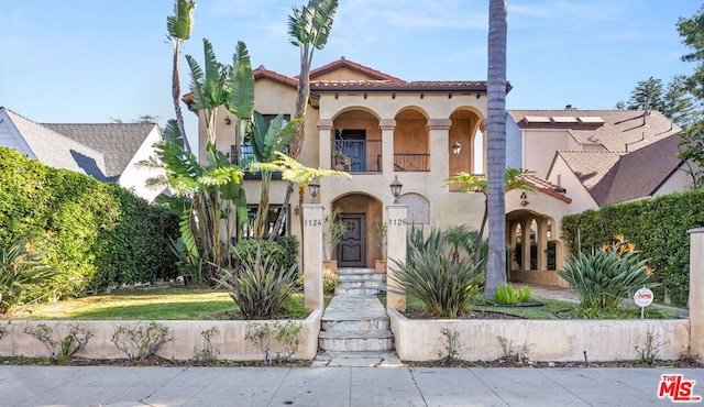 mediterranean / spanish-style house featuring a balcony