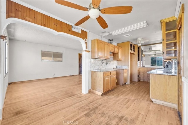 kitchen with ceiling fan, light hardwood / wood-style flooring, tasteful backsplash, and light brown cabinets