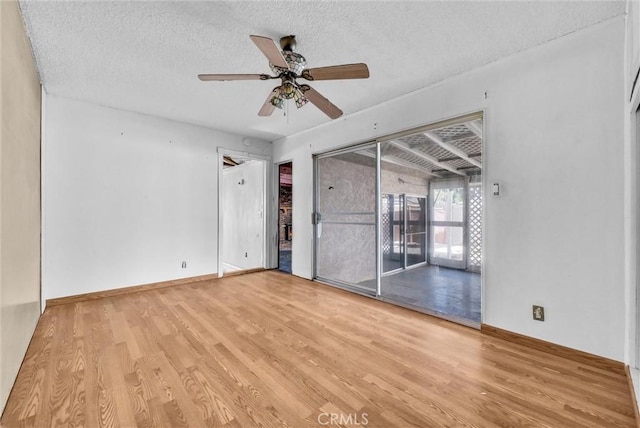 spare room featuring vaulted ceiling, a textured ceiling, ceiling fan, and light hardwood / wood-style floors