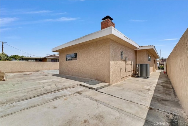 1307 N O Malley Ave, Covina, CA 91722 - view of home's exterior featuring central air condition unit, stucco siding, a patio area, and a chimney