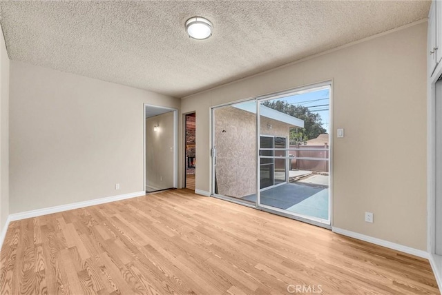 1307 N O Malley Ave, Covina, CA 91722 - empty room with light wood-style floors and a textured ceiling