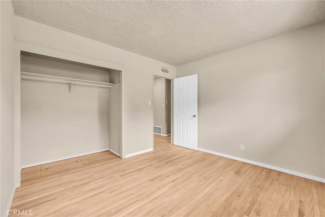 1307 N O Malley Ave, Covina, CA 91722 - unfurnished bedroom with wood finished floors, a closet, and a textured ceiling