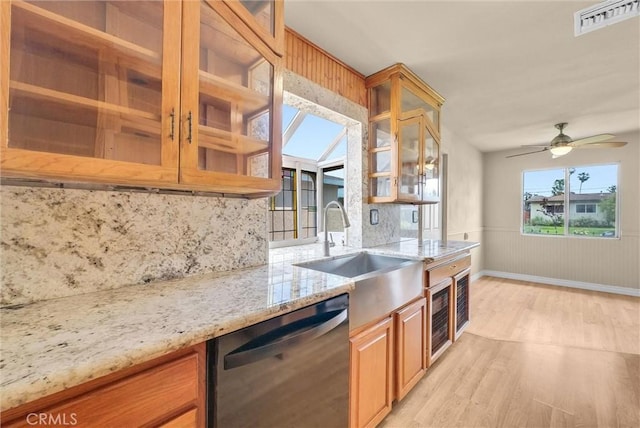 1307 N O Malley Ave, Covina, CA 91722 - kitchen featuring dishwashing machine, light wood-type flooring, decorative backsplash, light stone counters, and glass insert cabinets