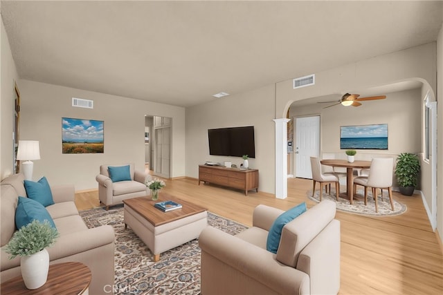 1307 N O Malley Ave, Covina, CA 91722 - living room with arched walkways, light wood-style flooring, ceiling fan, and baseboards
