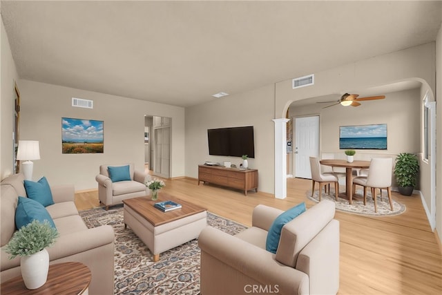 1307 N O Malley Ave, Covina, CA 91722 - living room featuring arched walkways, light wood-type flooring, and a ceiling fan