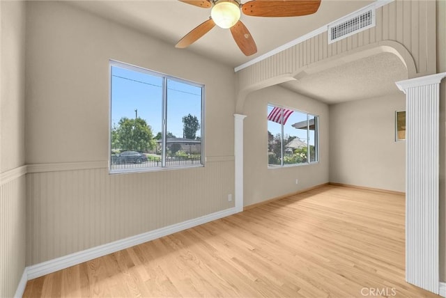 1307 N O Malley Ave, Covina, CA 91722 - spare room featuring wood finished floors, a ceiling fan, ornate columns, and a wainscoted wall