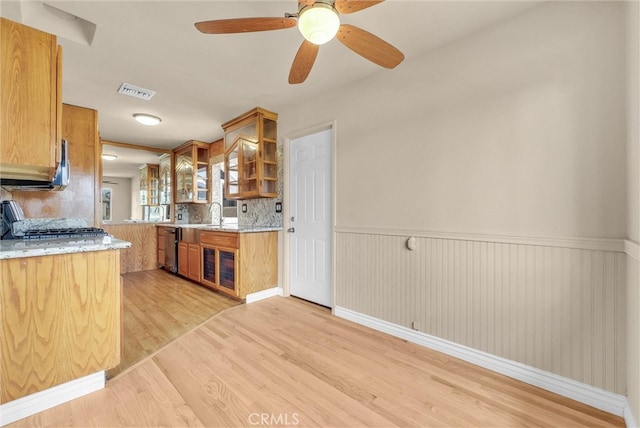 1307 N O Malley Ave, Covina, CA 91722 - kitchen with light wood finished floors, stove, a wainscoted wall, glass insert cabinets, and brown cabinets
