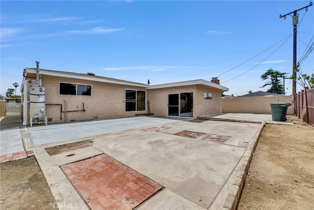 1307 N O Malley Ave, Covina, CA 91722 - rear view of house with stucco siding, a fenced backyard, and a patio area