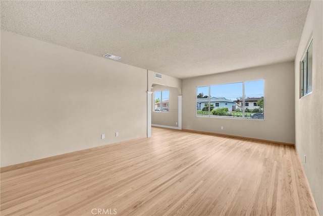 1307 N O Malley Ave, Covina, CA 91722 - empty room with light wood-style flooring and a textured ceiling