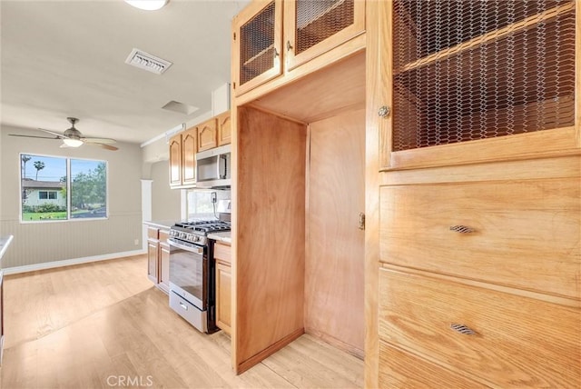 1307 N O Malley Ave, Covina, CA 91722 - kitchen with stainless steel appliances, light wood-style flooring, light countertops, and glass insert cabinets