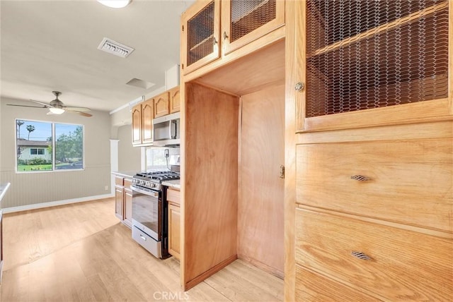 1307 N O Malley Ave, Covina, CA 91722 - kitchen featuring stainless steel appliances, light wood finished floors, light countertops, glass insert cabinets, and wainscoting