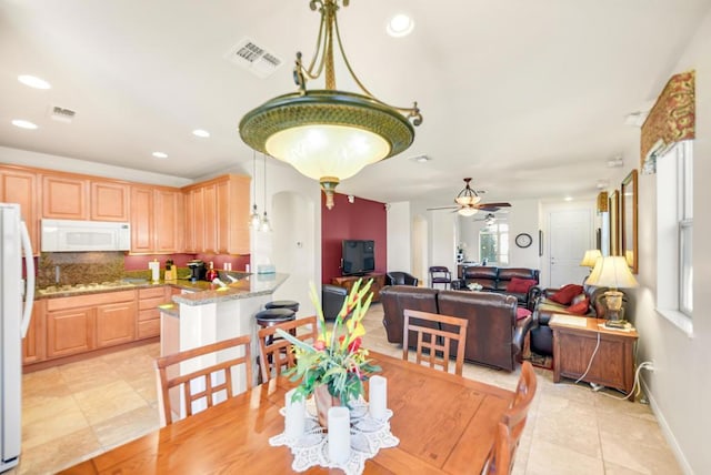 dining room featuring ceiling fan and light tile patterned floors