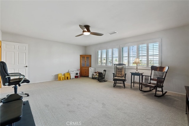 sitting room featuring ceiling fan and carpet floors