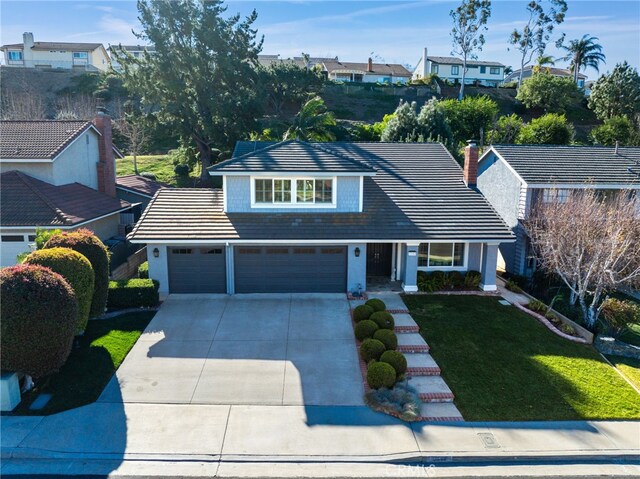 view of front of house with a garage and a front yard