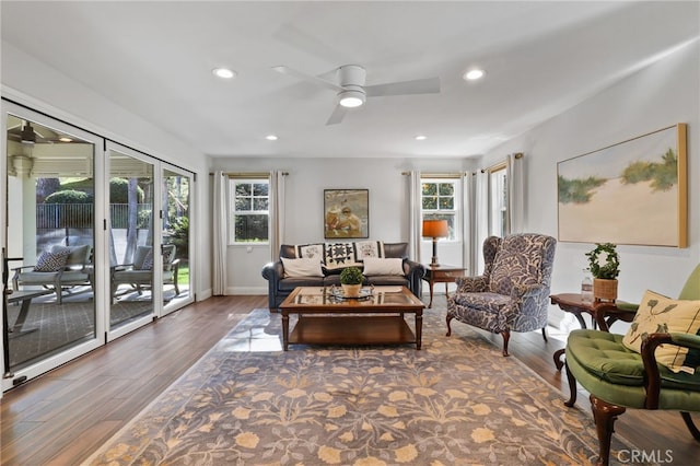 living room featuring ceiling fan and dark hardwood / wood-style floors