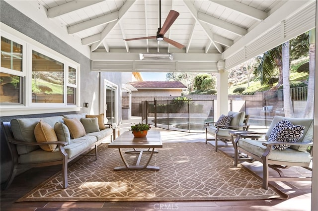 sunroom with ceiling fan and vaulted ceiling with beams