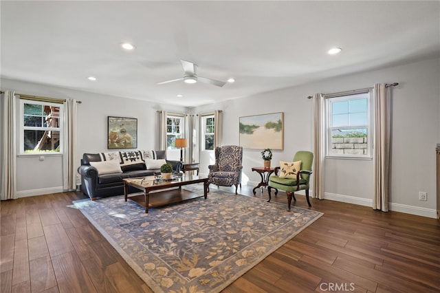 living room with ceiling fan and dark hardwood / wood-style flooring