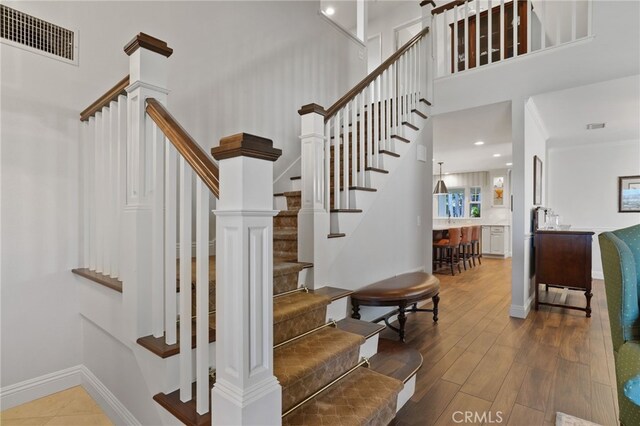 staircase with wood-type flooring