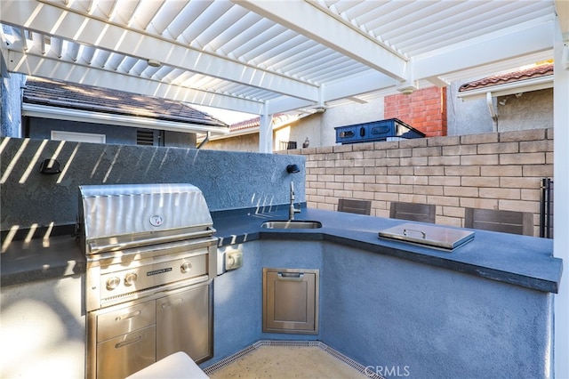 view of patio with grilling area, a pergola, an outdoor kitchen, and sink