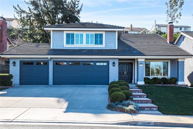 view of front property featuring a front lawn and a garage