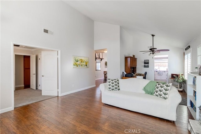 living room featuring high vaulted ceiling, ceiling fan, and dark wood-type flooring