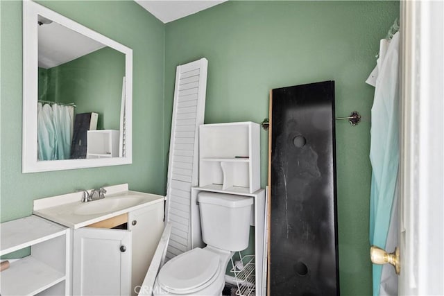 bathroom with toilet and vanity