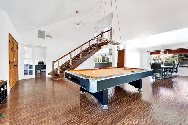 playroom with a healthy amount of sunlight, dark hardwood / wood-style flooring, billiards, and an inviting chandelier