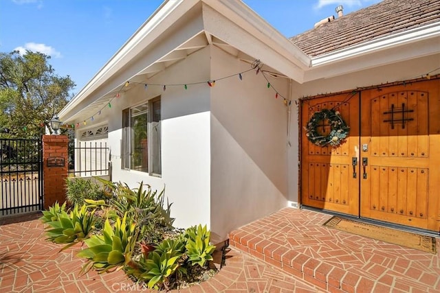 property entrance featuring a tiled roof and stucco siding